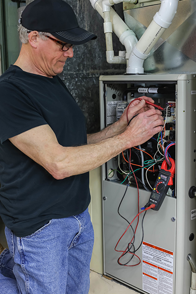 Furnace repair Rumson, Rumson furnace repair technician working on furnace wiring