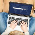Person on laptop with a search engine open